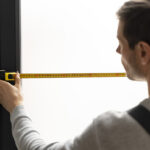Man measuring an window shade