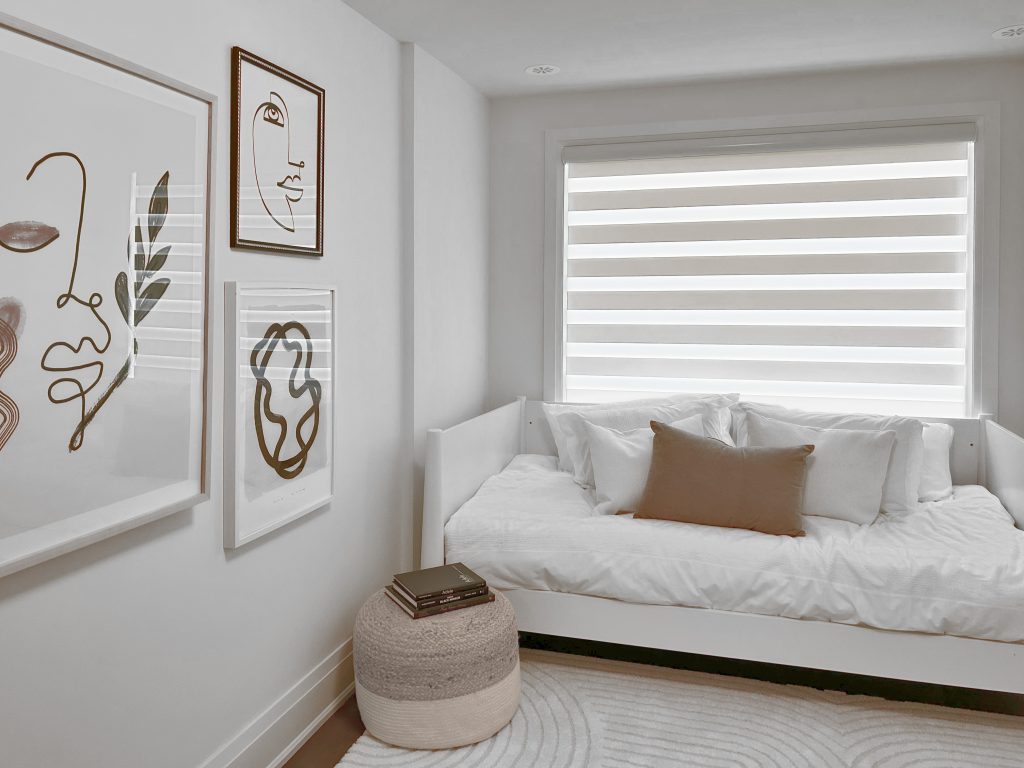 Zebra dual roller shade in a minimalist guest bedroom with neutral decor and modern artwork.